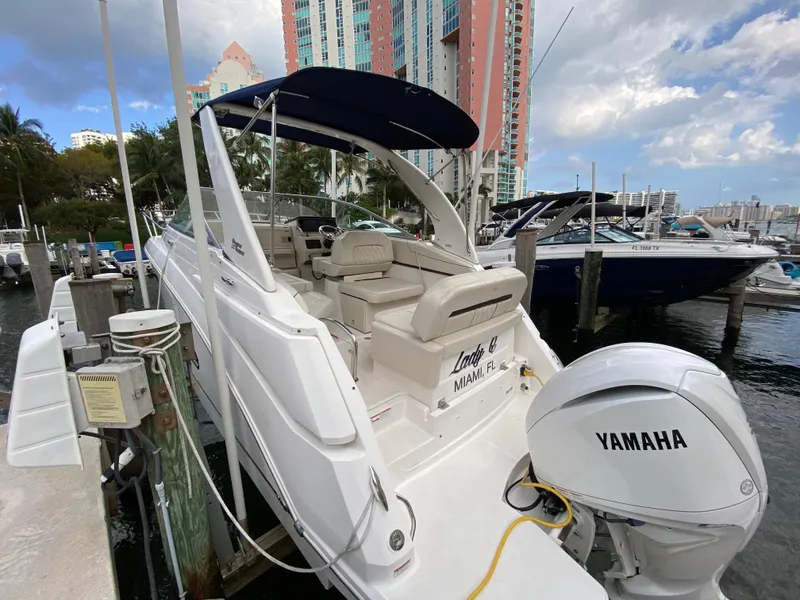 Slide: The Image of 2022 Regal 26 XO boat docked, featuring Yamaha outboard motor, in a marina setting. - 11