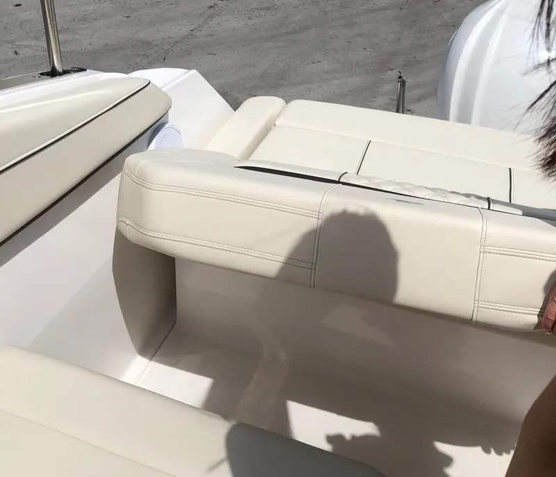 Slide: The Image of 2022 Regal 26 XO boat with beige leather seating, shadow visible. - 12