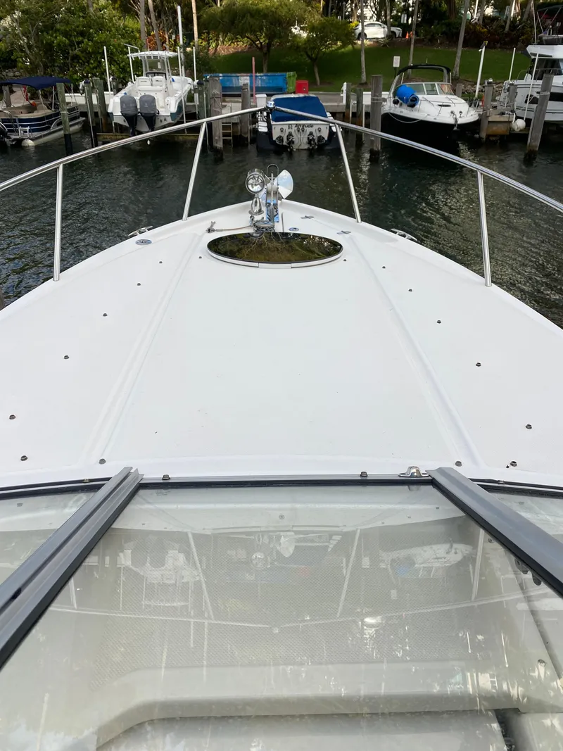 Slide: The Image of 2022 Regal 26 XO boat docked at marina, view from bow. - 13