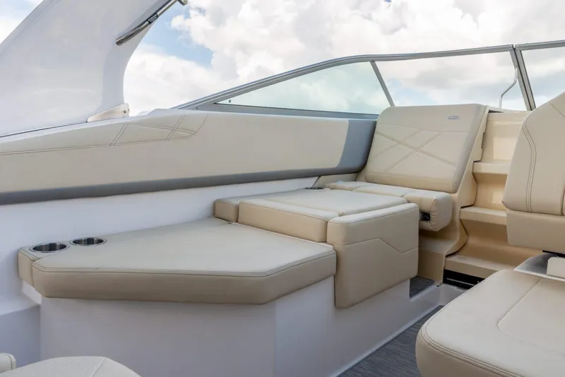 Slide: The Image of 2022 Regal 26 XO boat interior with beige seating and cup holders. - 15