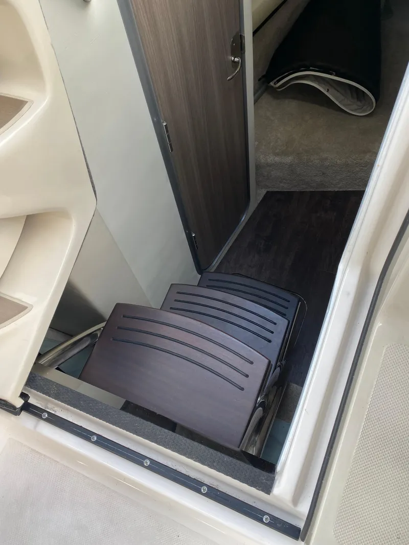 Slide: The Image of 2022 Regal 26 XO cabin entrance with wooden steps and interior view. - 19