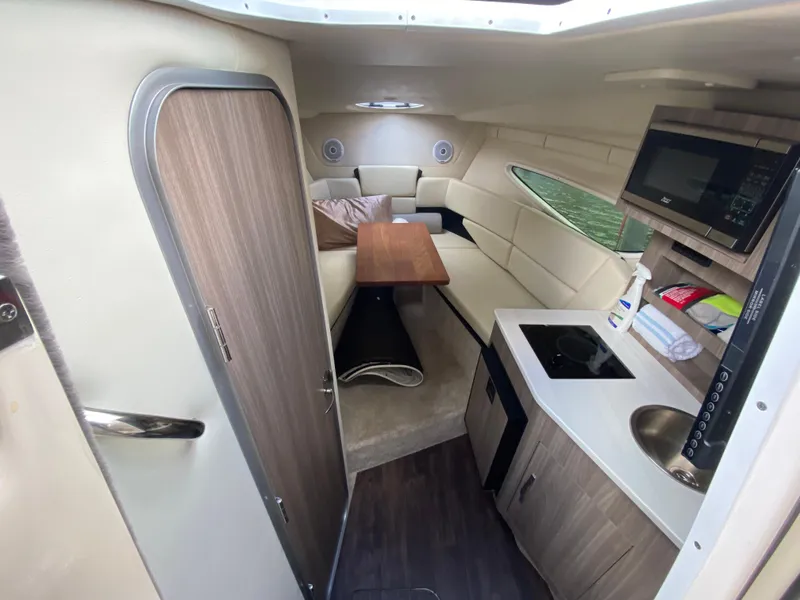 Slide: The Image of 2022 Regal 26 XO cabin interior with kitchenette, seating area, and modern amenities. - 22