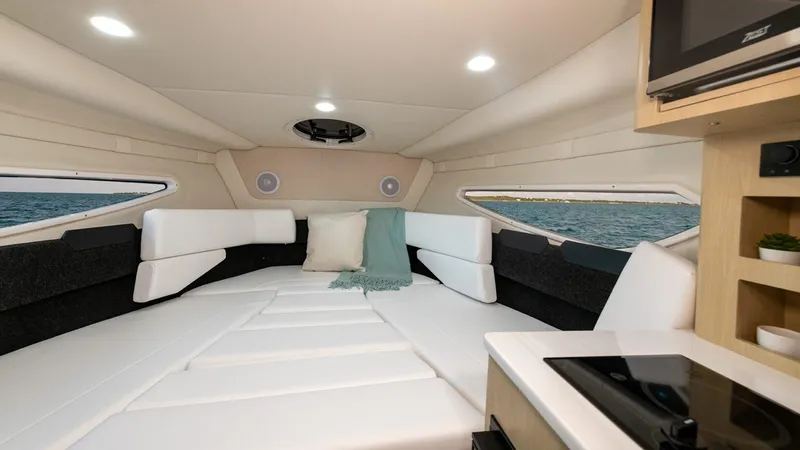 Slide: The Image of Interior of 2022 Regal 26 XO boat, featuring a cozy cabin with modern amenities. - 23