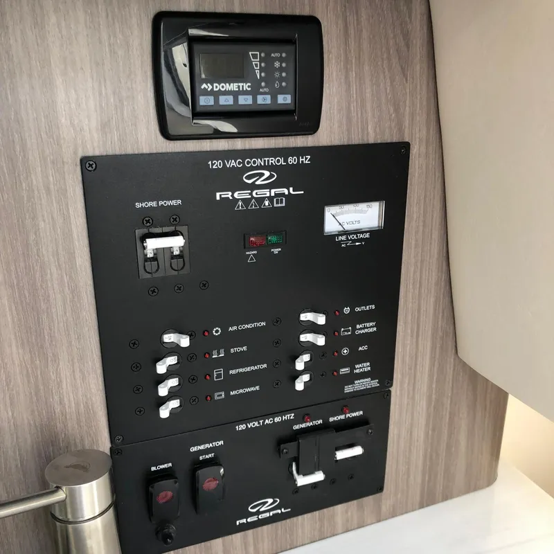 Slide: The Image of 2022 Regal 26 XO control panel with Dometic display, showcasing electrical system controls. - 24