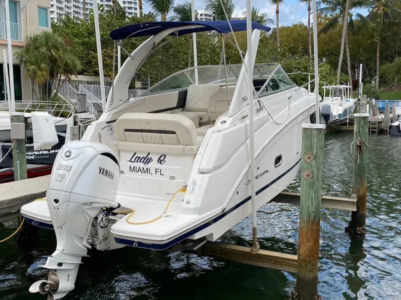 Slide: The Image of 2022 Regal 26 XO boat docked in Miami marina with Yamaha outboard engine. - 3