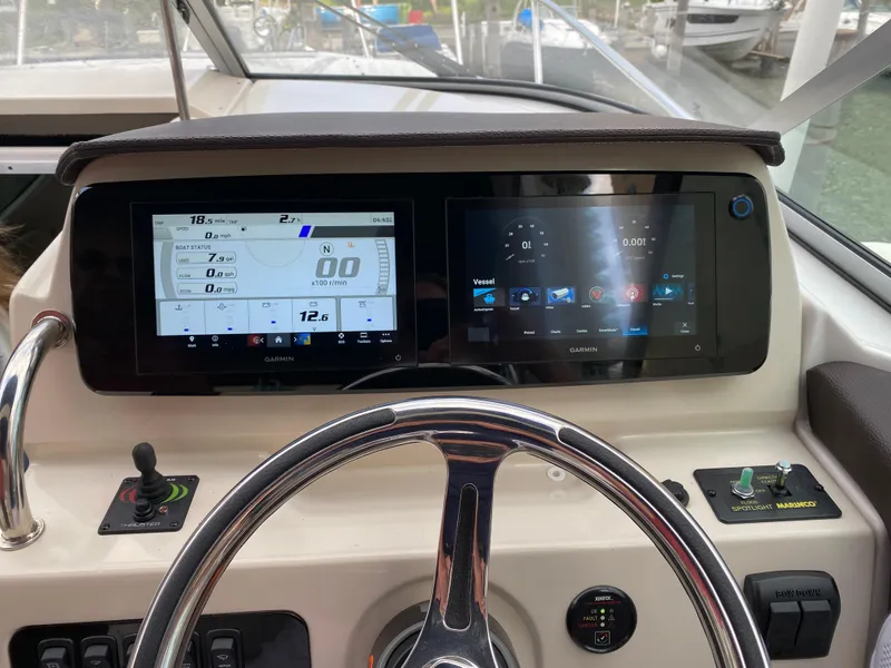 Slide: The Image of Helm of 2022 Regal 26 XO boat with dual Garmin displays and steering wheel. - 9