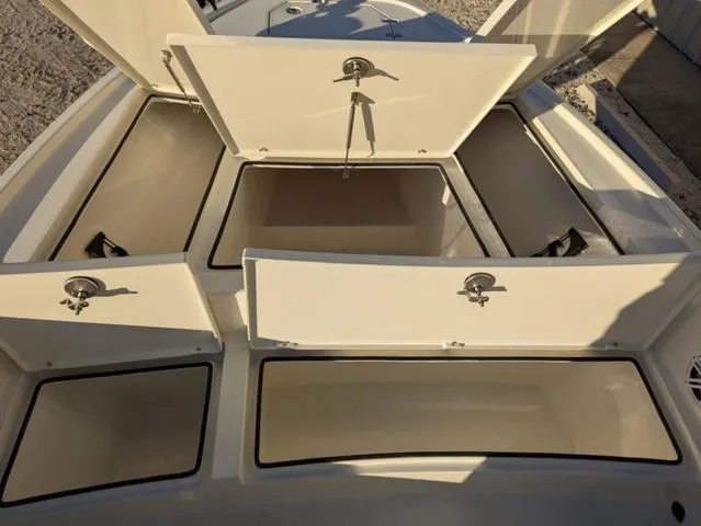 Slide: The Image of Open storage compartments on a 2025 Pathfinder 2500 Hybrid boat. - 12