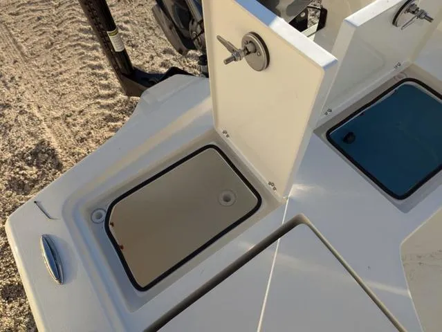 Slide: The Image of Pathfinder 2500 Hybrid 2025 boat deck with storage compartments and latch details. - 13