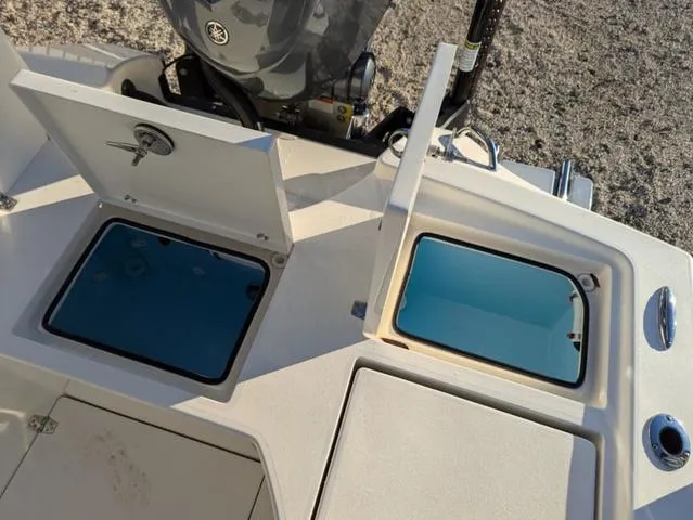 Slide: The Image of 2025 Pathfinder 2500 Hybrid boat with open storage compartments and engine view. - 14