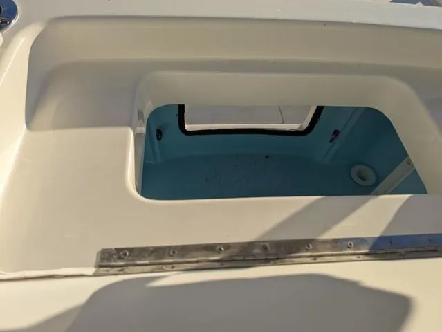 Slide: The Image of Open compartment on 2025 Pathfinder 2500 Hybrid boat, showcasing interior storage space. - 18