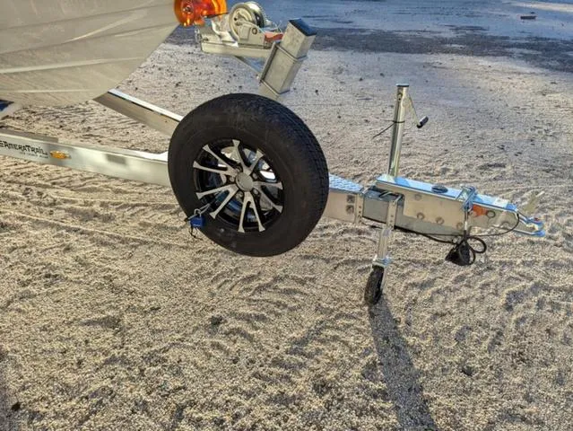 Slide: The Image of Trailer hitch and wheel of 2025 Pathfinder 2500 Hybrid on sandy ground. - 27