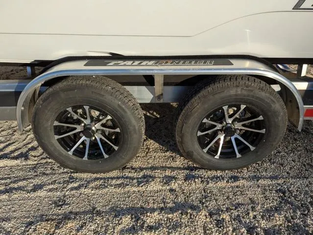 Slide: The Image of 2025 Pathfinder 2500 Hybrid trailer wheels on gravel surface. - 28
