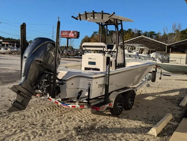 Slide: The Image of 2025 Pathfinder 2500 Hybrid boat on trailer, parked outdoors, featuring powerful outboard motor. - 4