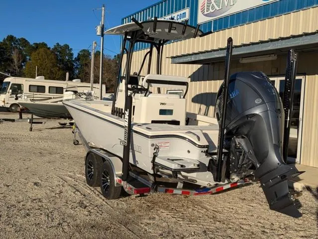 Slide: The Image of 2025 Pathfinder 2500 Hybrid boat on trailer, parked outside a building. - 5