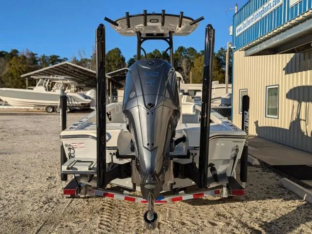 Slide: The Image of 2025 Pathfinder 2500 Hybrid boat with powerful outboard motor, parked outdoors near a building. - 6
