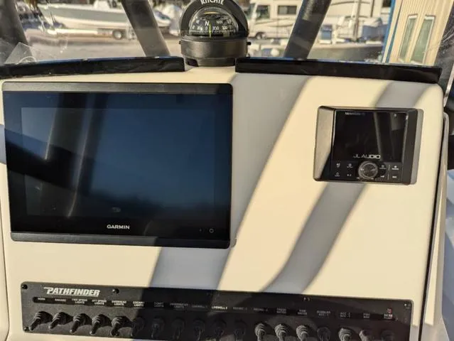 Slide: The Image of Control panel of 2025 Pathfinder 2500 Hybrid boat with Garmin and JL Audio systems. - 9