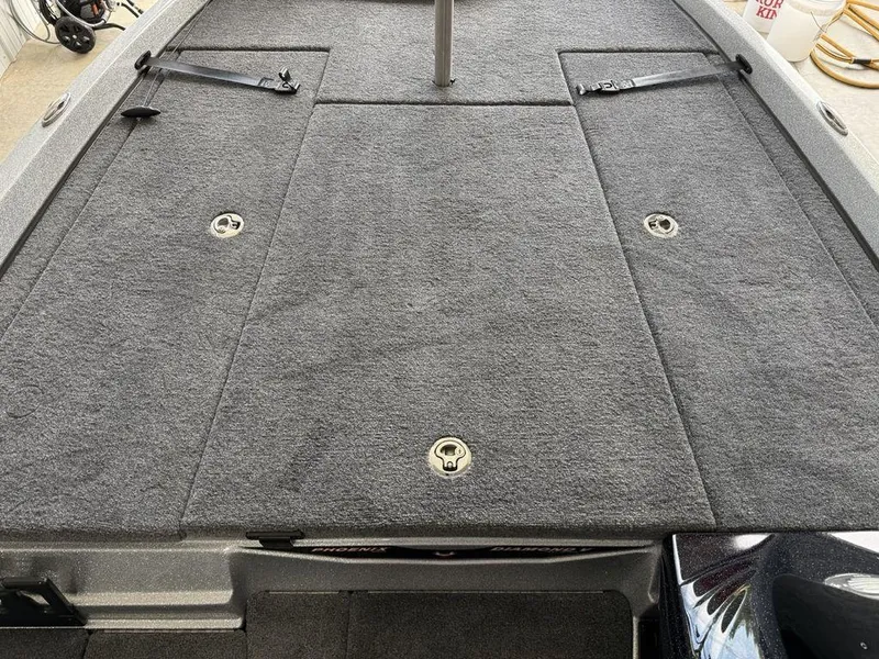 Slide: The Image of 2025 Phoenix 721 ZXL boat deck with gray carpet and storage compartments. - 12