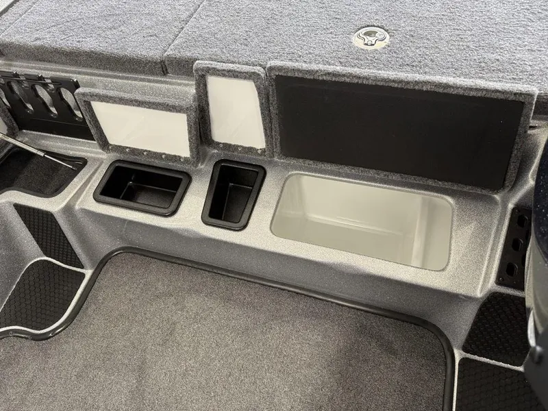 Slide: The Image of Interior of 2025 Phoenix 721 ZXL boat with storage compartments and carpeted flooring. - 14