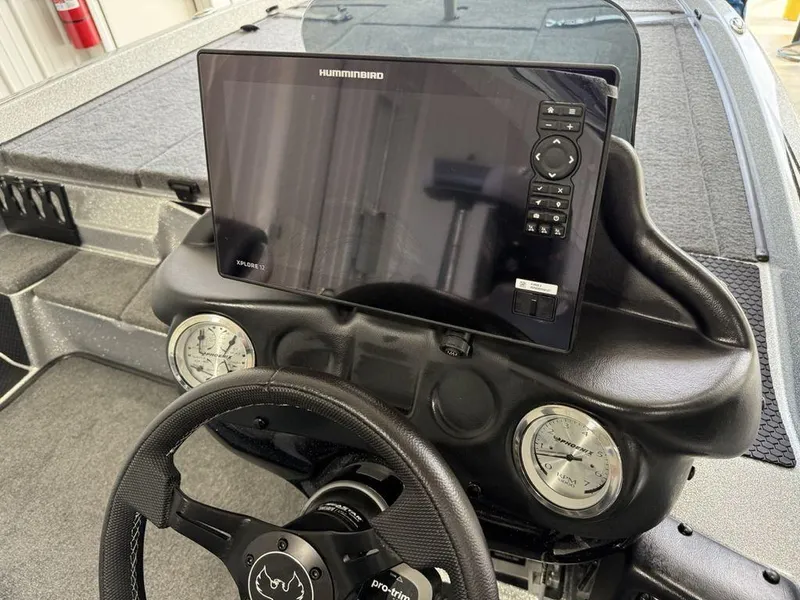 Slide: The Image of Dashboard of 2025 Phoenix 721 ZXL boat with Humminbird display and steering wheel. - 16