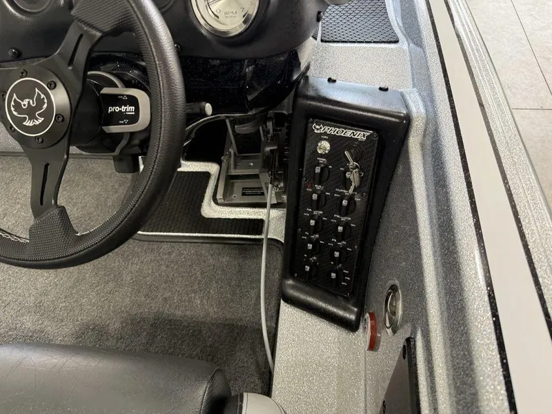 Slide: The Image of Interior of 2025 Phoenix 721 ZXL boat showing steering wheel and control panel. - 19