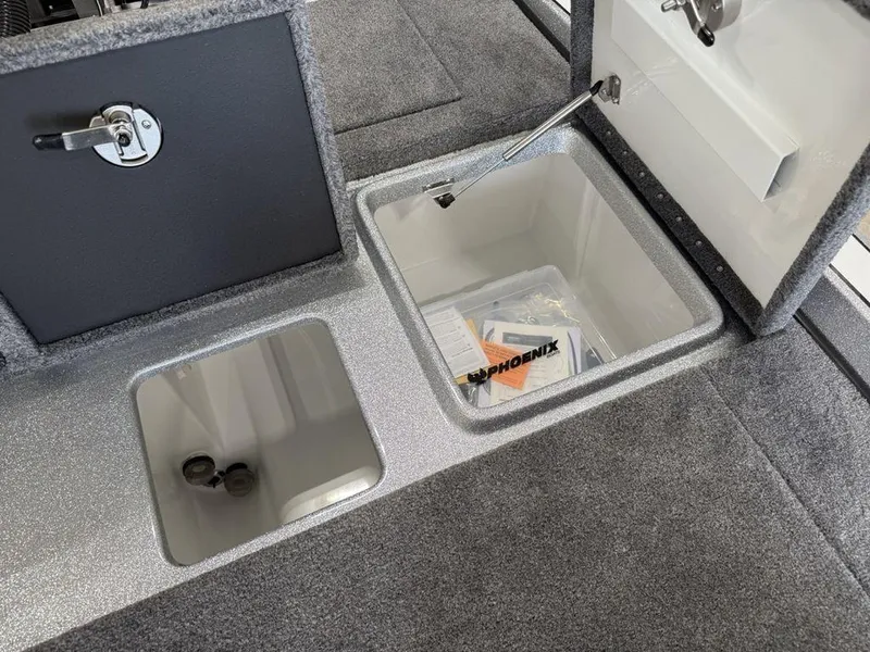 Slide: The Image of Phoenix 721 ZXL 2025 boat storage compartments with open lids, showcasing interior space. - 23
