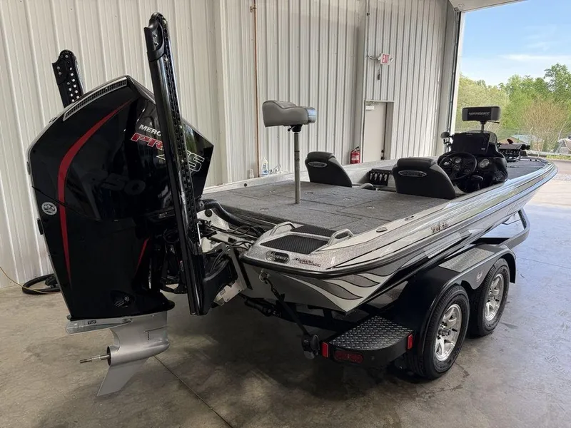 Slide: The Image of 2025 Phoenix 721 ZXL boat in garage, featuring powerful outboard motor and dual-axle trailer. - 3