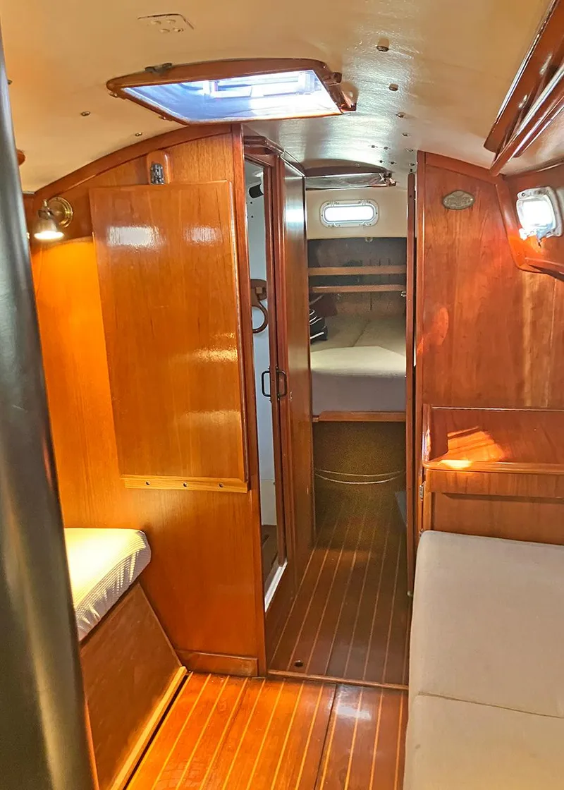 Slide: The Image of 1983 Freedom Cat Ketch interior with wooden finish, cozy seating, and natural light. - 11