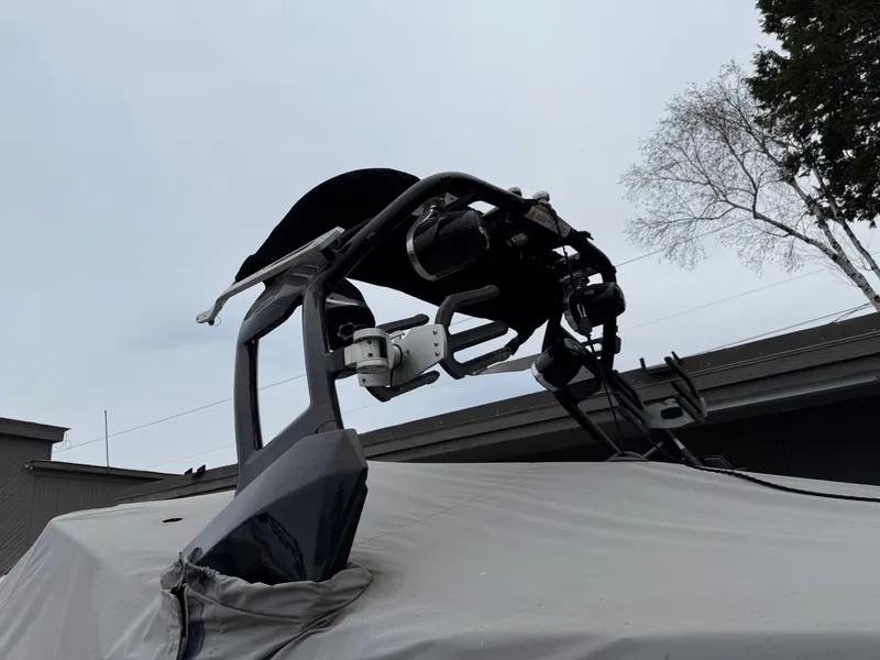 Slide: The Image of 2014 Supra Launch SC350-550 boat with a covered top and wakeboard tower. - 3