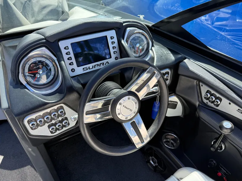 Slide: The Image of 2014 Supra Launch SC350-550 boat dashboard with steering wheel and control panel. - 4