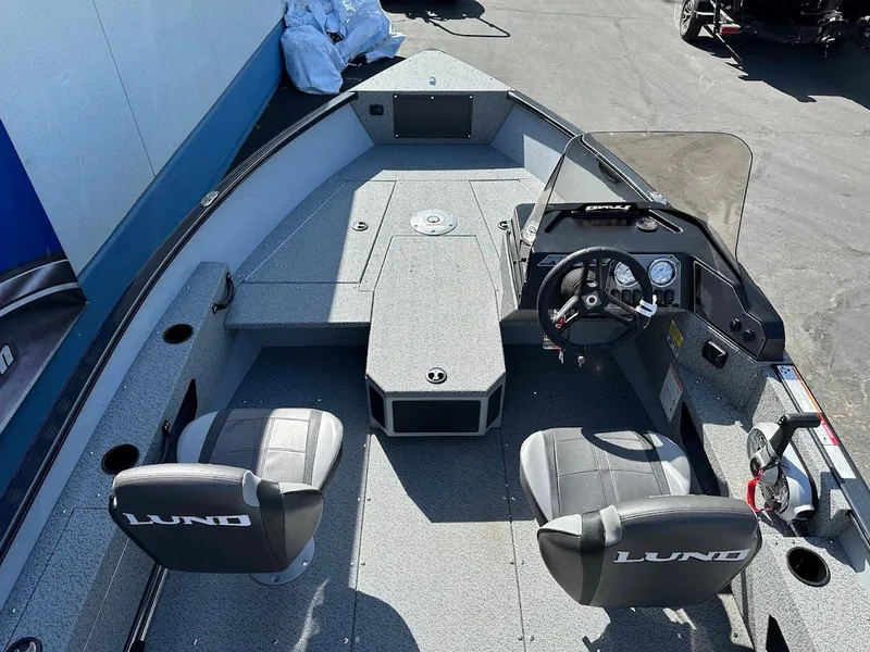 Slide: The Image of 2025 Lund 1675 Adventure SS boat interior with seating and steering console. - 10