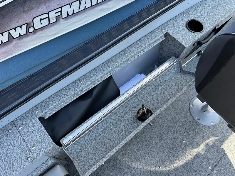 Slide: The Image of 2025 Lund 1675 Adventure SS boat interior storage compartment with textured flooring. - 14