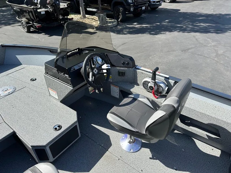 Slide: The Image of 2025 Lund 1675 Adventure SS boat interior with steering console and seating. - 15