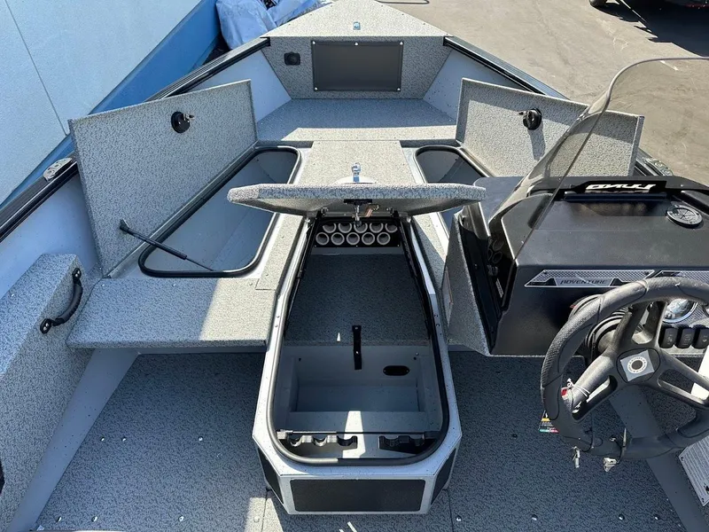 Slide: The Image of 2025 Lund 1675 Adventure SS boat interior with storage compartments and steering console. - 20