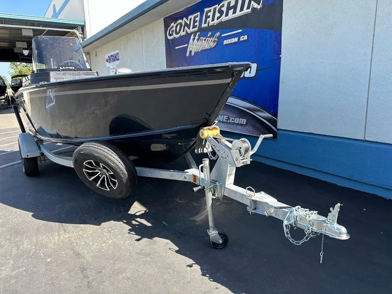 Slide: The Image of 2025 Lund 1675 Adventure SS boat on trailer, parked outside a fishing store. - 4