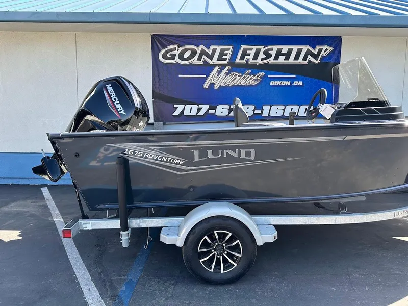 Slide: The Image of 2025 Lund 1675 Adventure SS boat on trailer, displayed at dealership. - 6