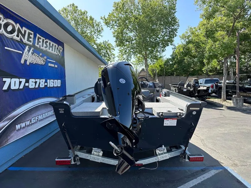 Slide: The Image of 2025 Lund 1675 Adventure SS boat on trailer, parked outside a fishing store. - 8