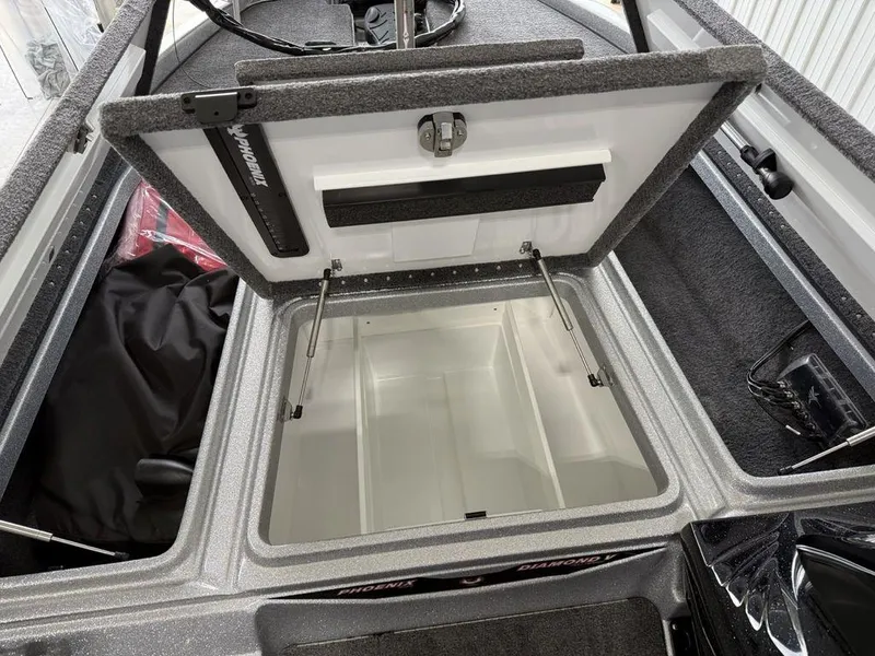 Slide: The Image of Open storage compartment in a 2025 Phoenix 920 Elite II boat. - 11