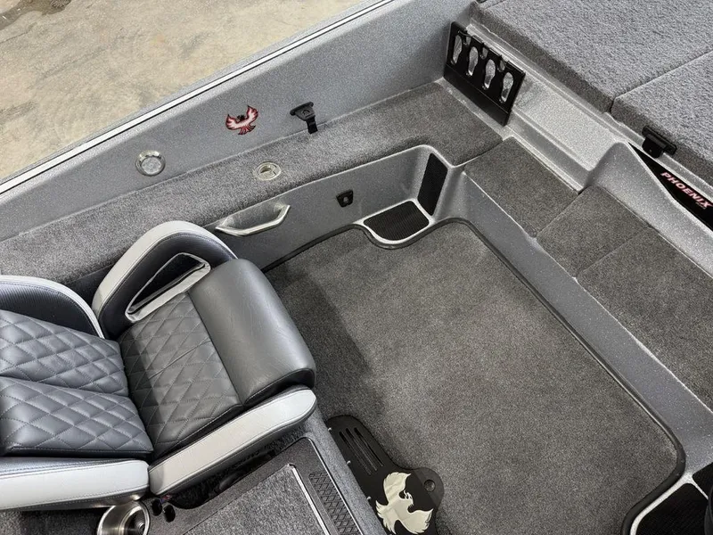 Slide: The Image of Interior of 2025 Phoenix 920 Elite II boat with gray seating and carpeted flooring. - 13