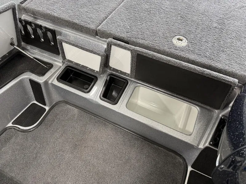 Slide: The Image of Interior of 2025 Phoenix 920 Elite II boat with storage compartments and carpeted flooring. - 14
