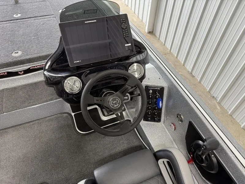 Slide: The Image of Cockpit of 2025 Phoenix 920 Elite II boat with steering wheel and navigation display. - 17