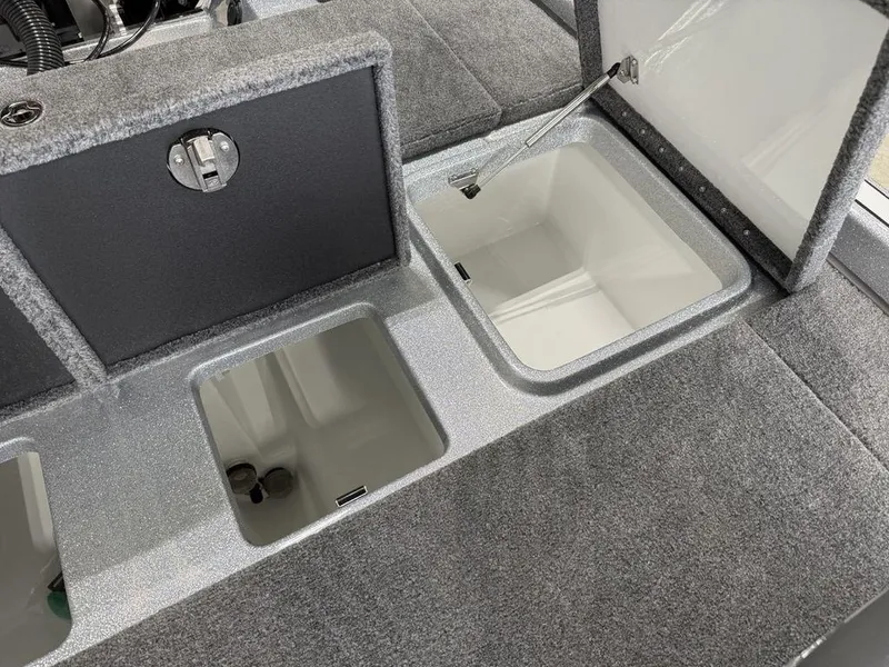 Slide: The Image of 2025 Phoenix 920 Elite II boat storage compartments with open lids, showcasing interior space. - 20