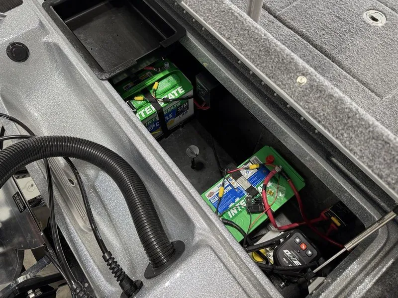 Slide: The Image of Open battery compartment of a 2025 Phoenix 920 Elite II boat, showing Interstate batteries. - 21