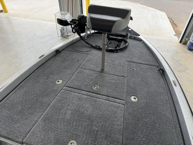 Slide: The Image of 2025 Phoenix 920 Elite II boat deck with gray carpet and seating. - 9