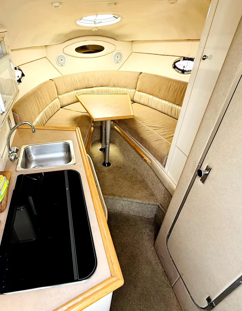 Slide: The Image of Interior of a 1998 Maxum 2700 SCR boat with kitchenette and seating area. - 10