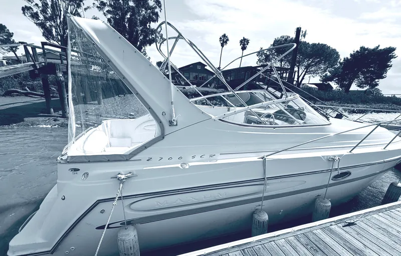 Slide: The Image of 1998 Maxum 2700 SCR boat docked, featuring sleek design and modern amenities. - 3