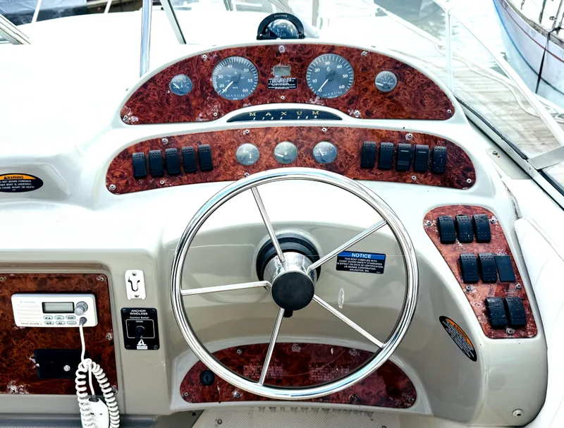Slide: The Image of 1998 Maxum 2700 SCR boat dashboard with steering wheel and control panel. - 5