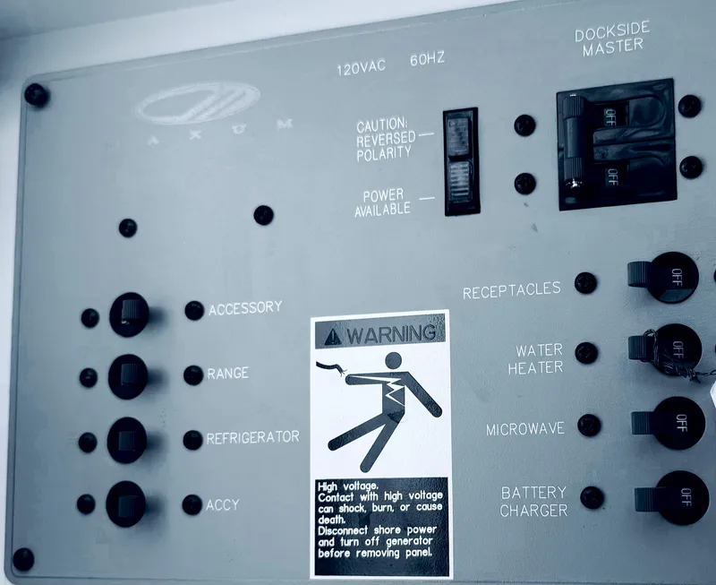Slide: The Image of Electrical panel of a 1998 Maxum 2700 SCR boat with various switches and warning label. - 7