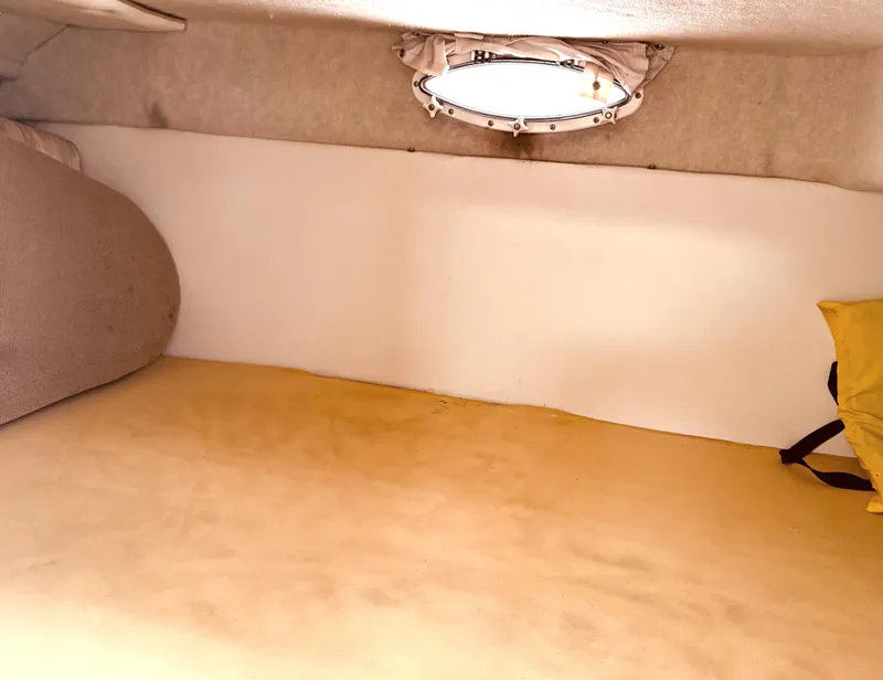 Slide: The Image of Interior cabin of a 1998 Maxum 2700 SCR boat, featuring a cozy sleeping area. - 9