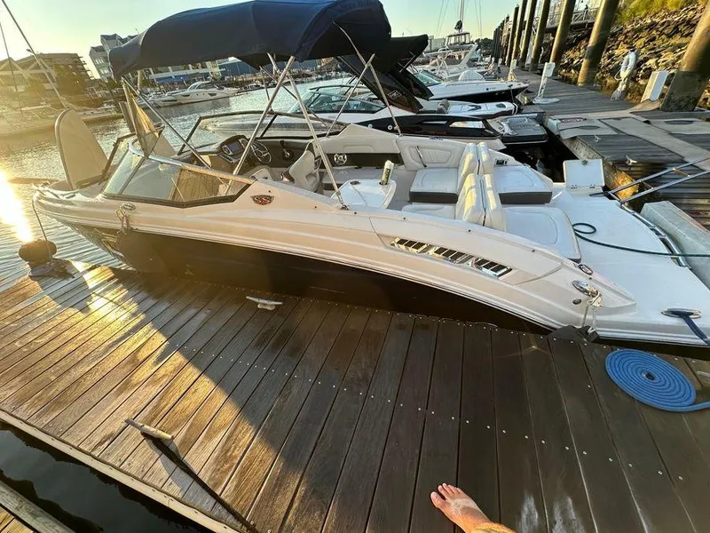 Slide: The Image of 2014 Chaparral 257 SSX boat docked at marina, sunset lighting. - 1
