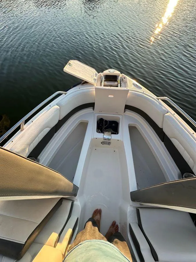 Slide: The Image of 2014 Chaparral 257 SSX boat interior with seating, viewed from above on calm water. - 10